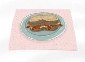 An illustrated bacon sandwich on a light blue plate and pink dotted placemat.