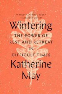 A red-orange book cover with the title, "Wintering: The Power of Rest and Retreat in Difficult Times," and the author's name, Katherine May, printed in black over a pale, cream-colored leaf.