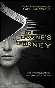 A black book cover with a gray sculpture of a woman's head which turns into a spiral staircase. Along the stairs, the title is The Heroine's Journey. The author is Gail Carriger.